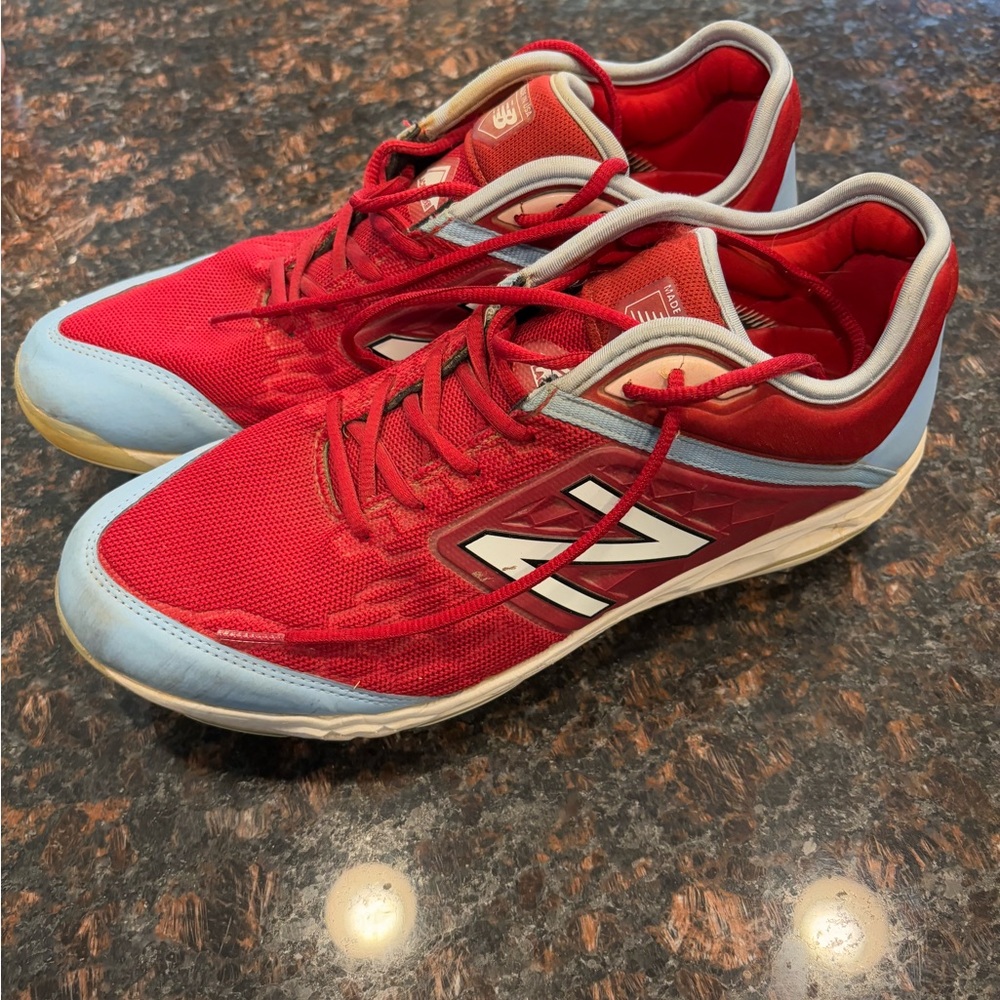 New Balance Red and light blue metal cleats